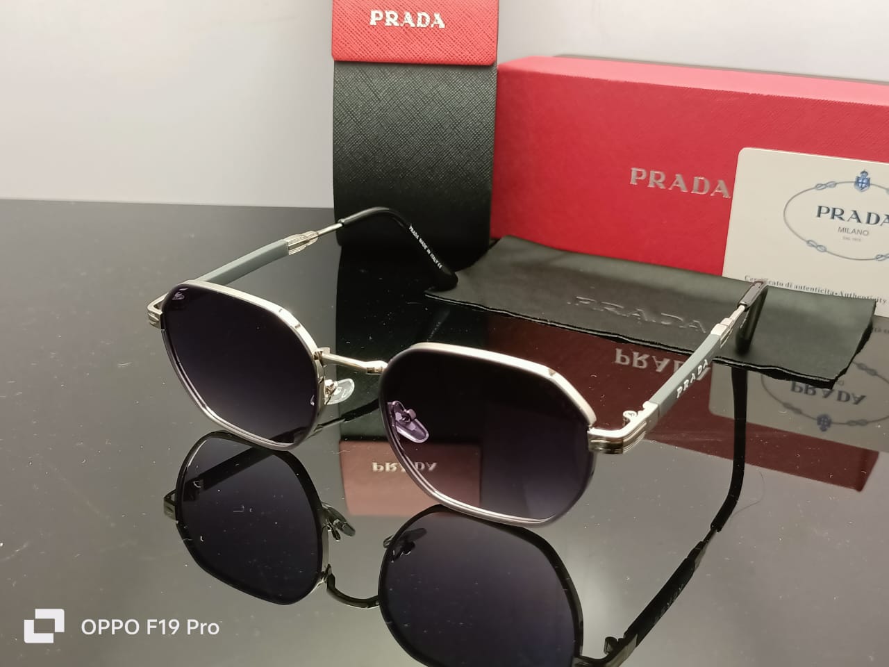 Prada Luxe Iconic Sunglasses Silver Frame | Gradient Black Lenses | Grey Temple Arms